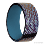 9 mm wide Flat Titanium Damascus band featuring a Royal Blue sleeve.
